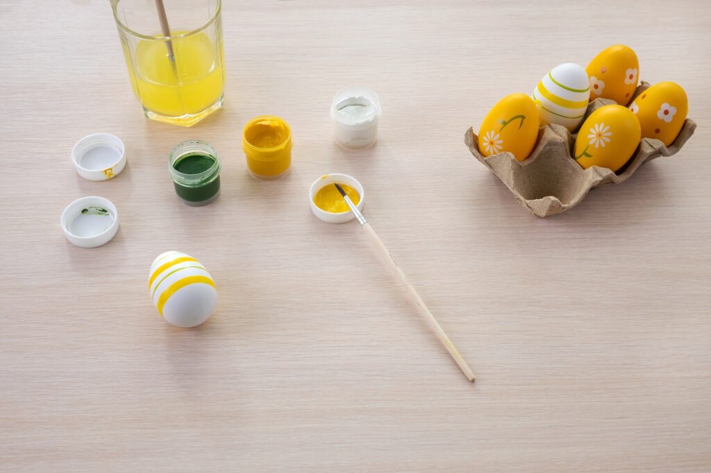 easter eggs and paints, festive decor, top view